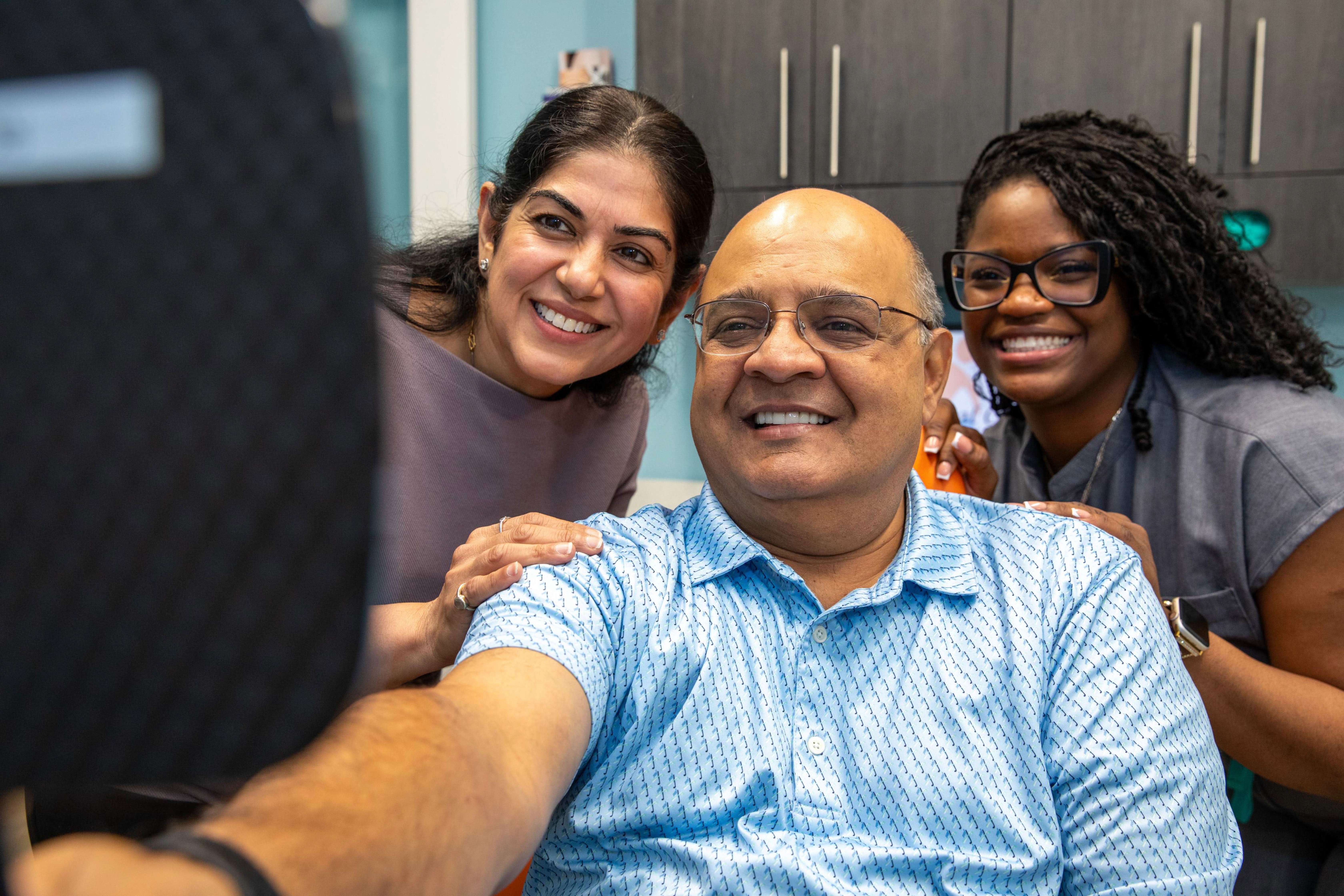 A patient seeing their new smile with Dr. Dham
