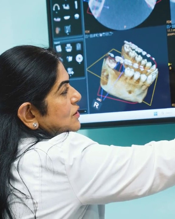 Dr. Uttma Dham planning dental implants on a 3D scan