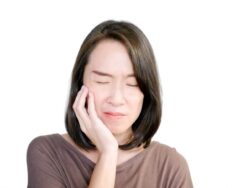 Woman suffering from jaw pain and bruxism